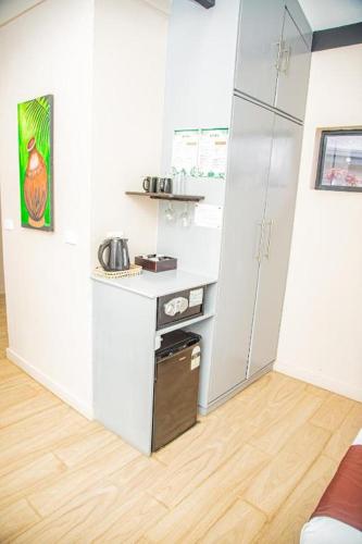 a white kitchen with a counter and a refrigerator at Seatiki Resort Fiji in Sigatoka