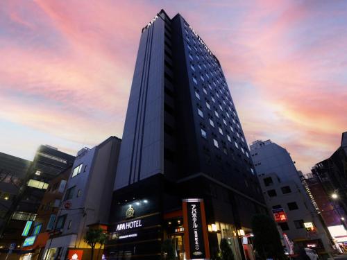 a tall building in the middle of a city at APA Hotel Ikebukuro Eki Kitaguchi in Tokyo