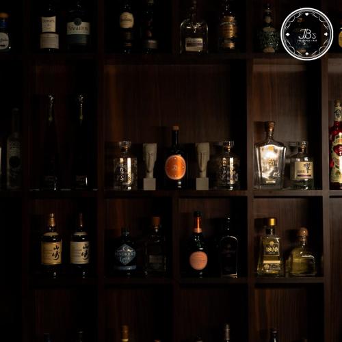 a shelf filled with lots of bottles of alcohol at Hotel Amar in Agra
