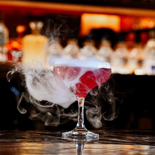 a glass with smoke in it sitting on a table at Hotel Amar in Agra