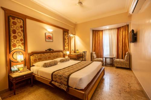 a hotel room with a large bed in a room at Pai Viceroy in Bengaluru
