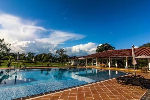 a large swimming pool in front of a building at Hotel Mastranto in Villavicencio