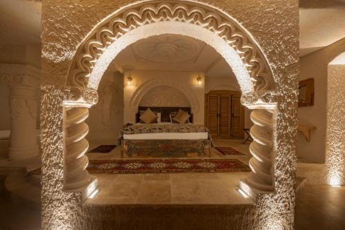 an archway in a bedroom with a bed in it at Harem Suites Cappadocia in Uchisar