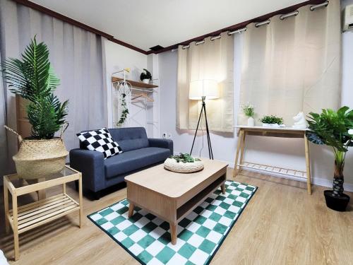 a living room with a blue couch and a table at the stay Paju in Paju