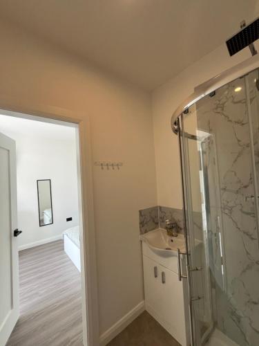 a bathroom with a shower and a sink at Deerpark 3 bed semi in Cashel