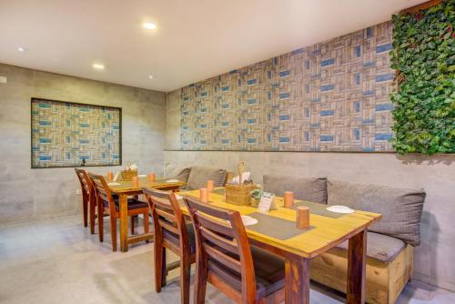 a restaurant with a table and chairs and a couch at Hotel Lokis Forest Inn L B Nagar in Surūrnagar