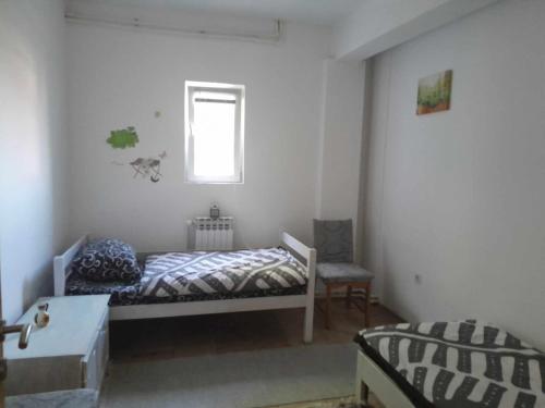 a bedroom with a bed and a window at Mountain Relax Vlašić in Vlasic