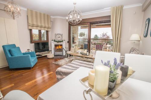 a living room filled with furniture and a fireplace at Evmorfes Villas in Poligiros