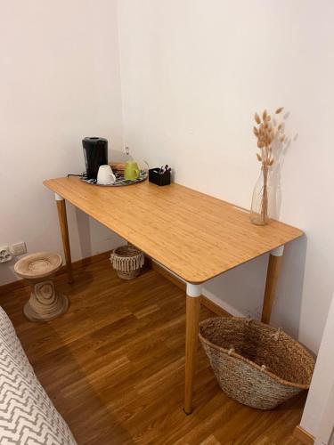 a wooden table in the corner of a room at Cosy Room in Vertou
