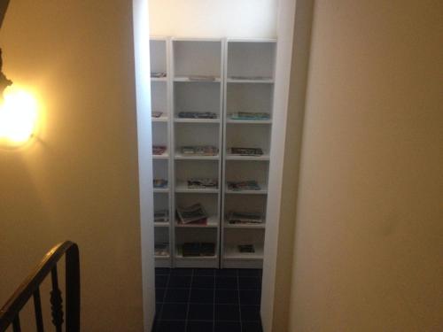 a hallway with a book shelf in a room at Hotel César Centre-ville Gare Charleville-Mézières in Charleville-Mézières