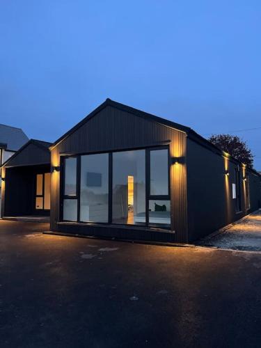 a black house with lights on the side of it at Deerpark 3 bed semi in Cashel