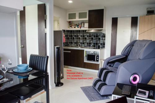 a living room with two chairs and a table at Blue and green Farang homes in Chiang Mai