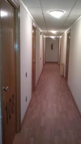 an empty hallway of an office building with a long corridor at Hotel Los Angeles in Guarnizo