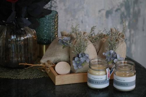 a table with two jars of jam and eggs and a candle at Style Jaritz in Ban Bang Phai