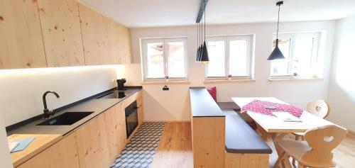 a kitchen with a bench and a table in it at Yeti Lodge in Sedrun