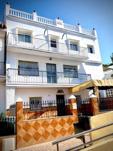 a white building with balconies on the side of it at Villasultana 1 in Chipiona
