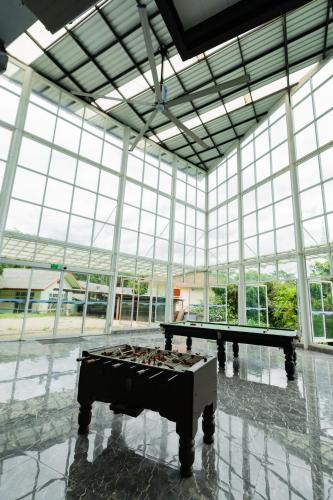 a large room with two ping pong tables in it at A Hotel Cozy in Ban Pa Sak