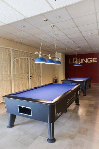 two pool tables in a room with two ping pong tables at Apartment 540, Oberharz, mit Schwimmbad und Sauna in Braunlage
