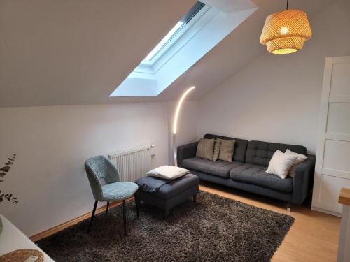 a living room with a couch and a chair at apartmentHAUSmannstätten in Hausmannstätten