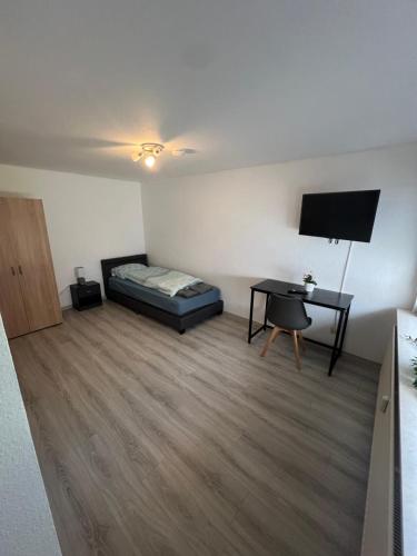 a bedroom with a bed and a desk in a room at Herrenalber in Bad Herrenalb