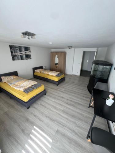 a room with two beds and a chair in it at Herrenalber in Bad Herrenalb