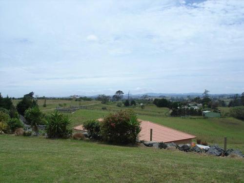 a house on a hill with a green field at Country Getaway House in Port Albert