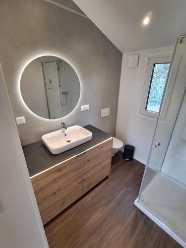 a bathroom with a sink and a mirror at LandZeit - get your tiny moments in Sohren