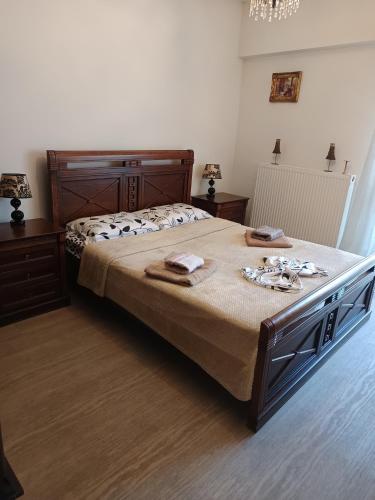 a bedroom with a large bed with towels on it at Sweet Home Lina in Paralia Katerinis