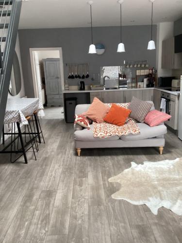 a living room with a couch and a kitchen at 2 bedroom apartment in Horwich