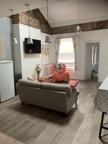 a living room with a couch and a chair at 2 bedroom apartment in Horwich