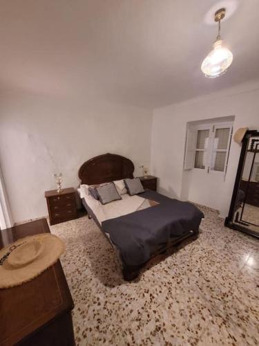 a bedroom with a bed and a table in it at Maison avec piscine privée in Cabra del Santo Cristo