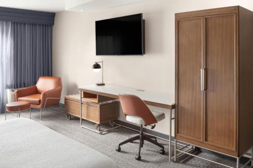 a hotel room with a desk and a chair at Courtyard Portland Airport in South Portland
