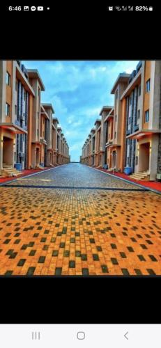 a view of an empty street with rows of buildings at New villa on the marina sea in Ash Shihābīyah
