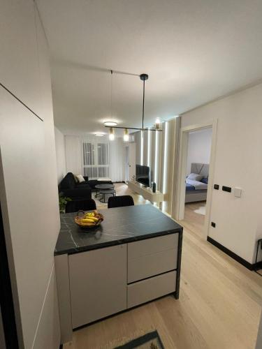 a kitchen and living room with a island in a room at Apartman1105 Sarajevo Free Garage in Sarajevo