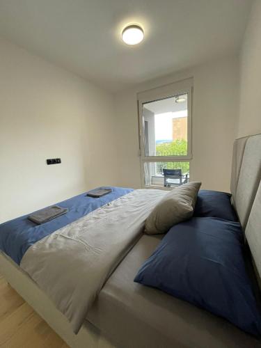 a large bed in a bedroom with a window at Apartman1105 Sarajevo Free Garage in Sarajevo
