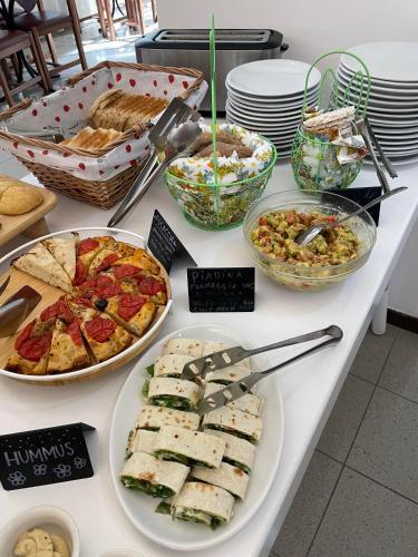 a buffet filled with different types of food on a table at Hotel Reale in Rimini