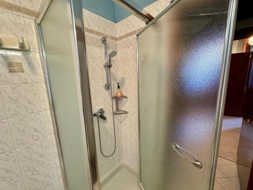 a shower with a glass door in a bathroom at B&B La Borasca - Apartments in Casalpusterlengo