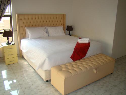 a bed and a couch in a bedroom at Pomona BB House in Harare