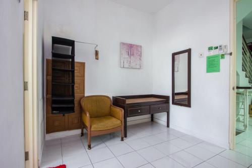 a room with a desk and a chair and a mirror at Nautilus Bay Home Inn in George Town
