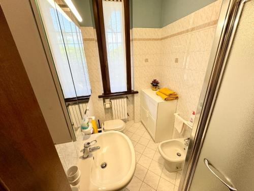 a bathroom with a sink and a toilet at B&B La Borasca - Apartments in Casalpusterlengo