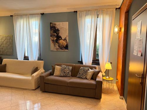 a living room with a couch and a chair at B&B La Borasca - Apartments in Casalpusterlengo