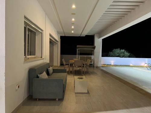 a living room with a couch and a table at Villa ALKANTARA - 4 Bedroom in Ouled Yaneg