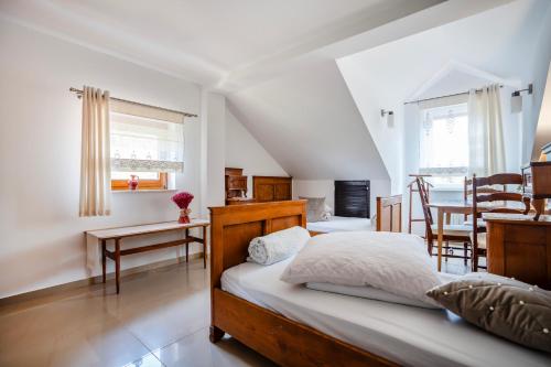 a bedroom with a bed and a dining room at ForRest House Jacuzzi & Sauna in Jasienica