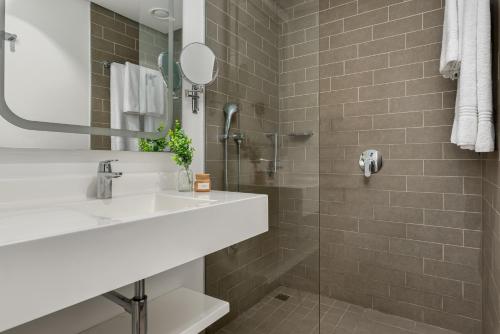 a bathroom with a sink and a shower at Neighbourgood Newlands in Cape Town