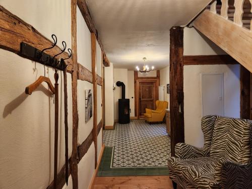 a hallway with a chair and a room at Ferienwohnungen Hermannsmuehle in Klausdorf