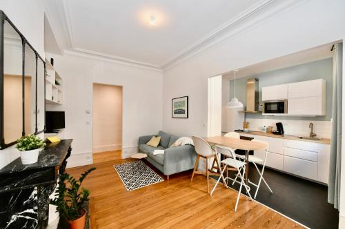 a kitchen and living room with a couch and a table at Le Havre De Paix in Le Perrey
