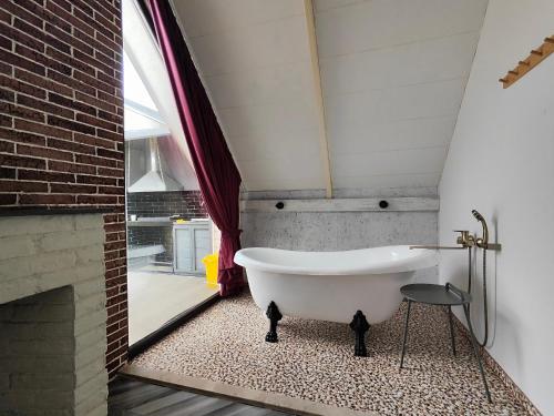 a bath tub in a bathroom with a fireplace at Mountain Resort Gabala in Nourkyshlak