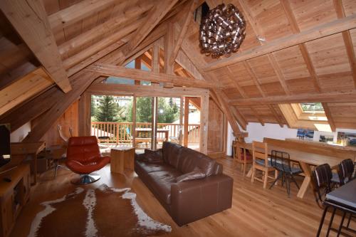 a living room with a leather couch and a table at Apartment 19 in La Salle Les Alpes