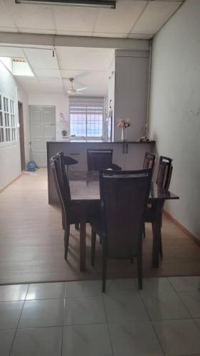 Un comedor con mesa y sillas en Ummi Homestay, en Kampong Batu Tiga