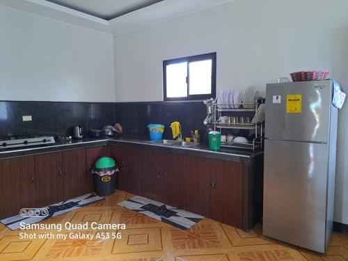 a kitchen with a stainless steel refrigerator in a room at Rudy's house in Matabungkay